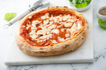 Traditional pepperoni pizza with fresh basil