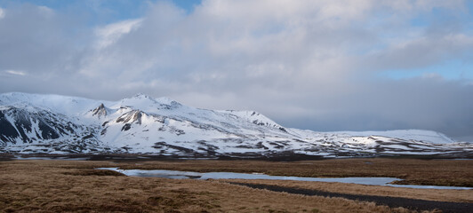 Icelandic landscape with mountains and meadow land covered in snow at snaefellsnes peninsula in...