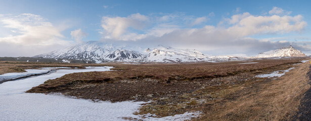 Icelandic landscape with mountains and meadow land covered in snow at snaefellsnes peninsula in Iceland