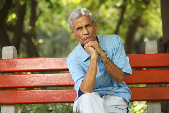 Portrait of a indian deep thinking old man at park - Powered by Adobe