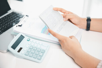 Business hands holding saving account passbook with calculator, account and saving concept. finance...