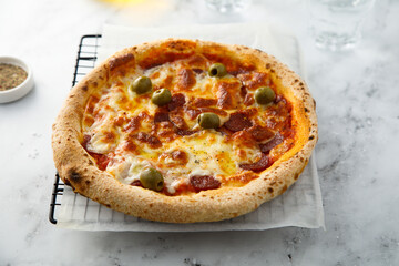 Traditional pizza with olives and cheese