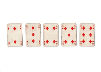 A poker hand of old grubby playing cards isolated on a white background.