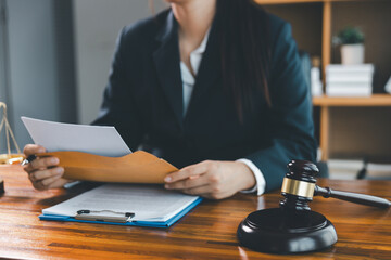 Justice and lawfirm concept. Female lawyer in office with brass scale. Woman hand gavel to bang. Law and justice trial session. Business lawyer notary stamping agreement, company secretary, validity.