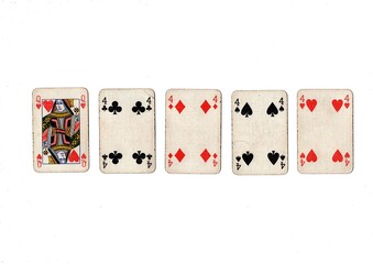 A poker hand of old grubby playing cards isolated on a white background.
