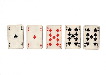 A poker hand of old grubby playing cards isolated on a white background.