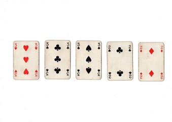 A poker hand of old grubby playing cards isolated on a white background.