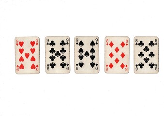 A poker hand of old grubby playing cards isolated on a white background.
