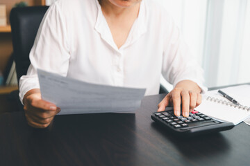 Using calculating machine, household carefully manages each bill and expense to plan financial budget, ensuring timely payment, consistent saving, smart investment for secure home finance strategy.