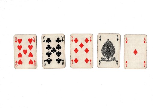 A poker hand of old grubby playing cards isolated on a white background.