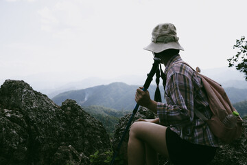Woman hiker on top of mountain. Hiker with arms up on top of mountain successful young woman...
