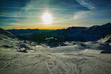 "Sunrise Over Snow-Covered Ski Slopes"

A breathtaking sunrise over vast, snow-covered ski slopes, with distant mountains silhouetted against the bright, low sun, creating a stunning winter wonderland