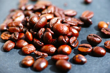 Roasted Coffee Beans Close-up
A close-up, high-angle view of a scattered pile of rich, dark brown...