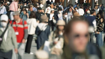 Unfocused blurry crowd of people walking in the street. Slow motion.	
 - Powered by Adobe