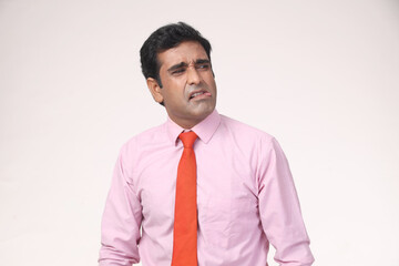 Indian Portraits of young confused sad business man, troubled, deep thought, isolated white background. Negative human emotions, facial expressions, life perception, reaction, attitude on studio.