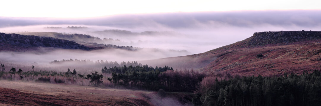 Panorama of early morning mist over Burbage Rocks and Higger Tor, Hathersage, Peak District, UK