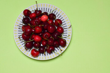 cherries on a green background, a top view