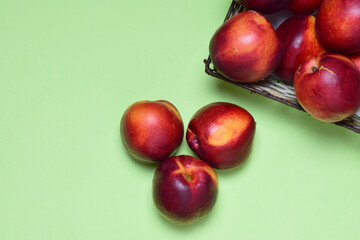 Zenith view, nectarine on green background and copy space.