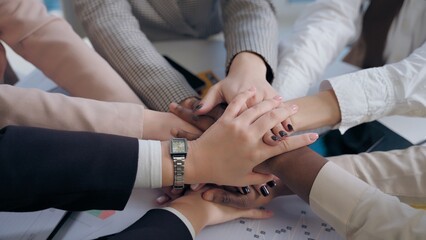 Obraz premium African American Japanese Hispanic multiethnic business women females team girls coworkers businesswomen hands arms folded in unity gesture cooperation teamwork partnership documents table at office