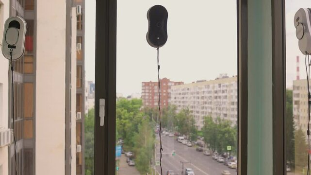 A man uses an automatic window cleaner for sparkling, crystal-clear glass and a spotless finish