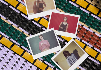 Four blank Polaroids rest on a colorful woven surface, showcasing a creative mockup perfect for showcasing memories or designs. PSD mockup