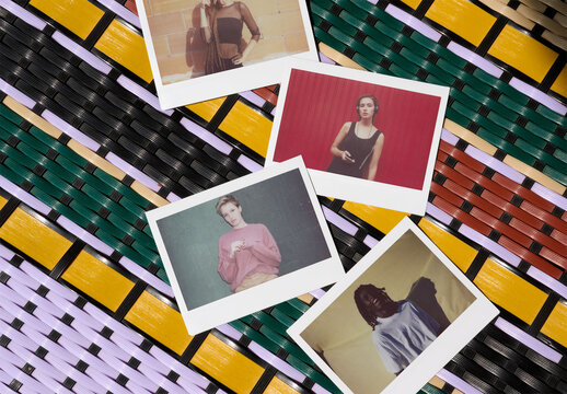 Four blank Polaroids rest on a colorful woven surface, showcasing a creative mockup perfect for showcasing memories or designs. PSD mockup