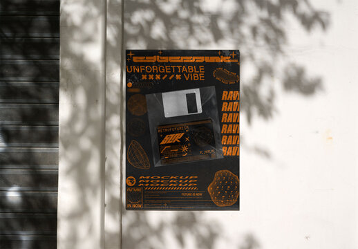 A blank poster is mounted on a wall, casting shadows from nearby foliage.PSD Mockup ready to use