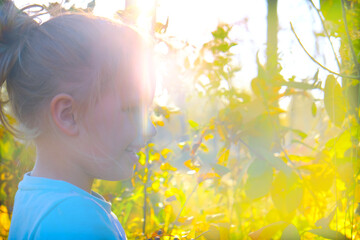 Happy child girl in the forest, walking, playful. Soft blurred sunlight. Enjoying Life and nature. Beaming light and atmospheric mood, cinematic blurred effect. Golden hour