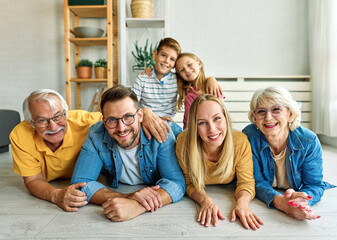 Portrait of a three generation famili, grandparents, parents and children sitting on sofa and...