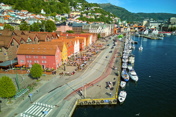 Aerial view of famous Bryggen with crowds of people and yachts in Bergen, Norway
