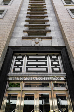 Quebec City, Quebec, Canada, June 21, 2025 - Vertical low angle view of the 1950 Maison de la coop&eacute;ration (House of Cooperation) door and tower at 155 Charest boulevard East in lower downtown
