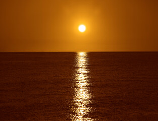 Bright beautiful sunset at the calm Black sea. Batumi, Georgia. Adjara region Solar sun disk over...