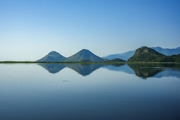 Mountains, water lilies and reeds on Skadar Lake, Montenegro – natural beauty of the Balkans