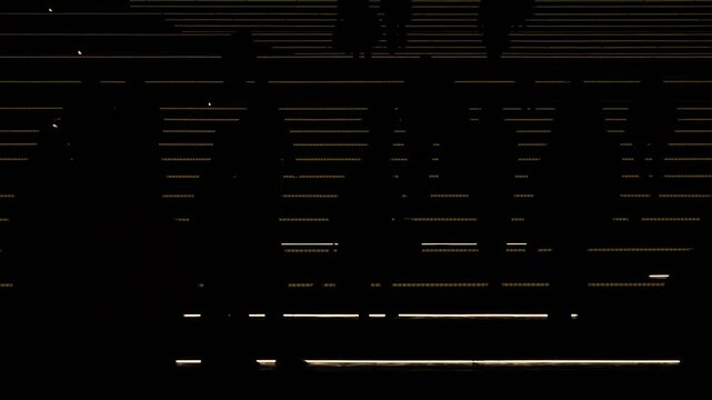 Artistic low angle tracking shot of crowd silhouettes moving across an illuminated modern electronic screen walkway.
