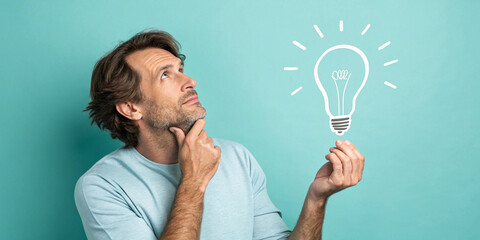 A Man Thinking with a Blank Lightbulb Concept on a Turquoise Background Representing Potential Ideas