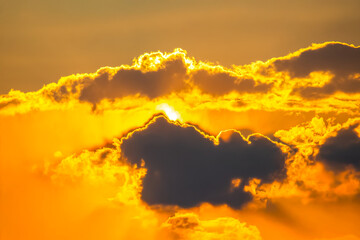 Ethereal sky filled with heavy clouds and golden light rays breaking through at sunset. Perfect for evoking emotion, nature photography, and creating a dramatic, serene ambiance.