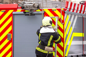 firefighter man works on his fire truck. fire safety service
