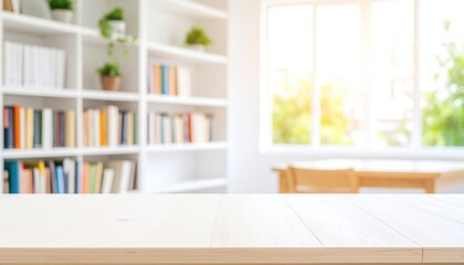 Fototapeta premium Empty light wooden table in front of a bright, well-stocked bookcase