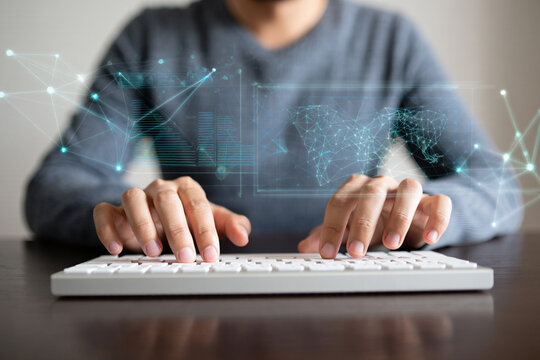 Person using keyboard with digital data visualization overlay