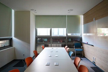 Interior of a university lecture room with neatly arranged desks and chairs for learning.