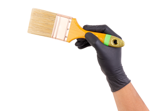 Hand wearing black glove holding a wide paintbrush with wooden handle, isolated on white background, ideal for painting or renovation themes.