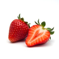 Two ripe strawberries, one sliced open, on white background showcasing juicy red flesh and green leaves.