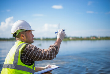 An inspector is inspecting water released by an industrial plant into a community public river.