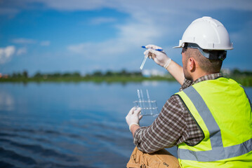 An inspector is inspecting water released by an industrial plant into a community public river.