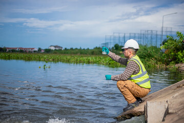 An environmental expert is collecting water samples from a treatment pond to be taken back to the...