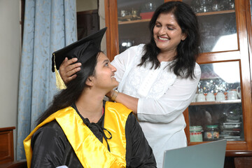 Indian Happy female graduation student with her mother. celebration and achievement. Family,...