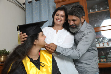 Indian Happy graduate student and proud parents celebrating graduation degree convocation ceremony...