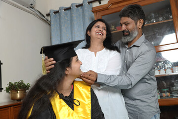 Indian Happy graduate student and proud parents celebrating graduation degree convocation ceremony...