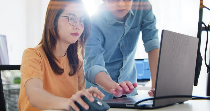 Asian male, female programming developer work together at home office, brainstorm discussion. Information technology, software engineer programmer coding job, man and woman coworker teamwork concept