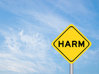 Yellow transportation sign with word harm on blue color sky background